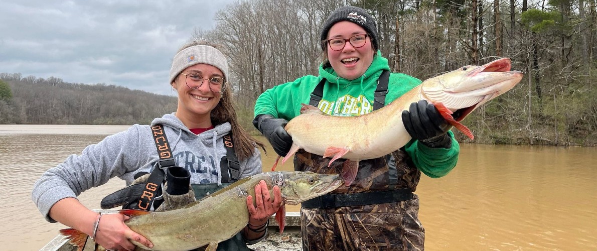 two woman holding fish
